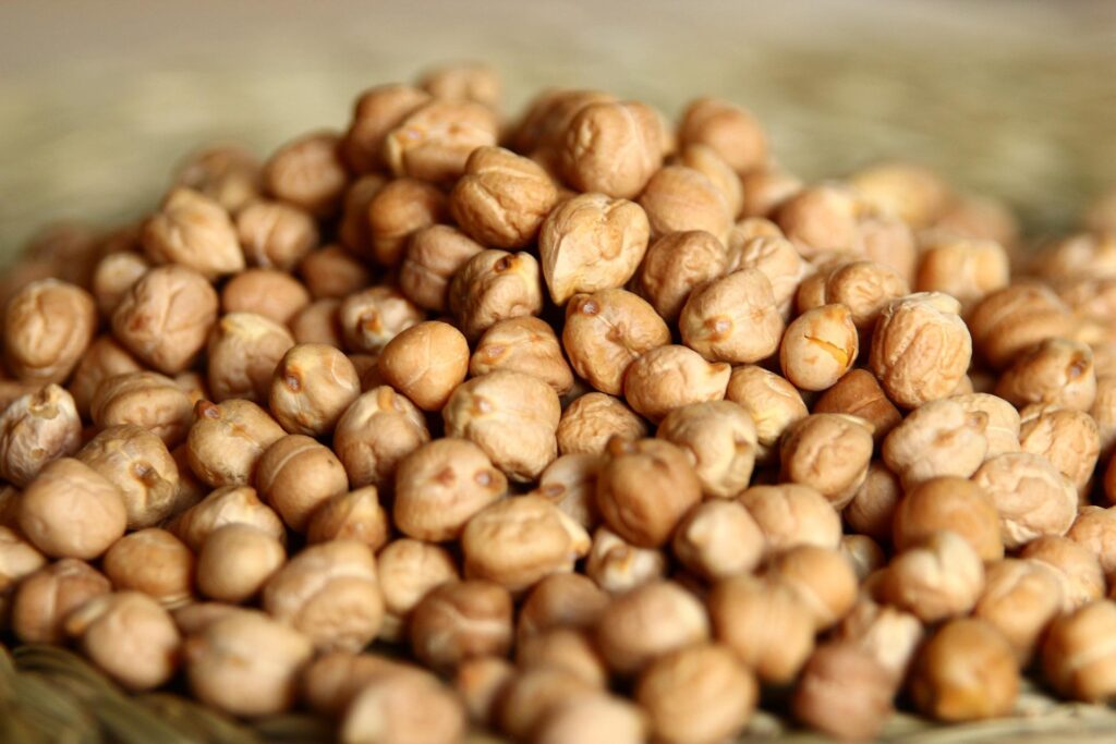 A close-up view of a pile of dried chickpeas.