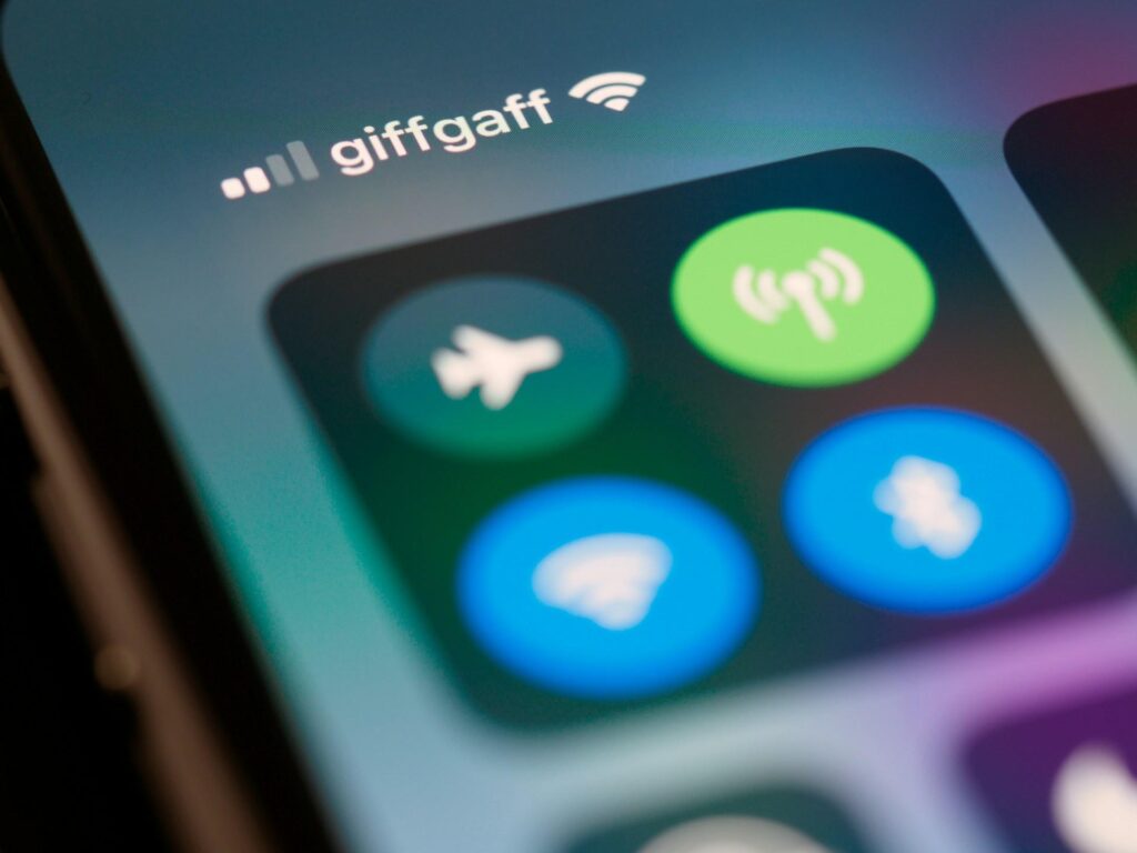 Close-up of a smartphone screen showing various control center options, including airplane mode, WiFi, and Bluetooth, with the "giffgaff" carrier name visible at the top.