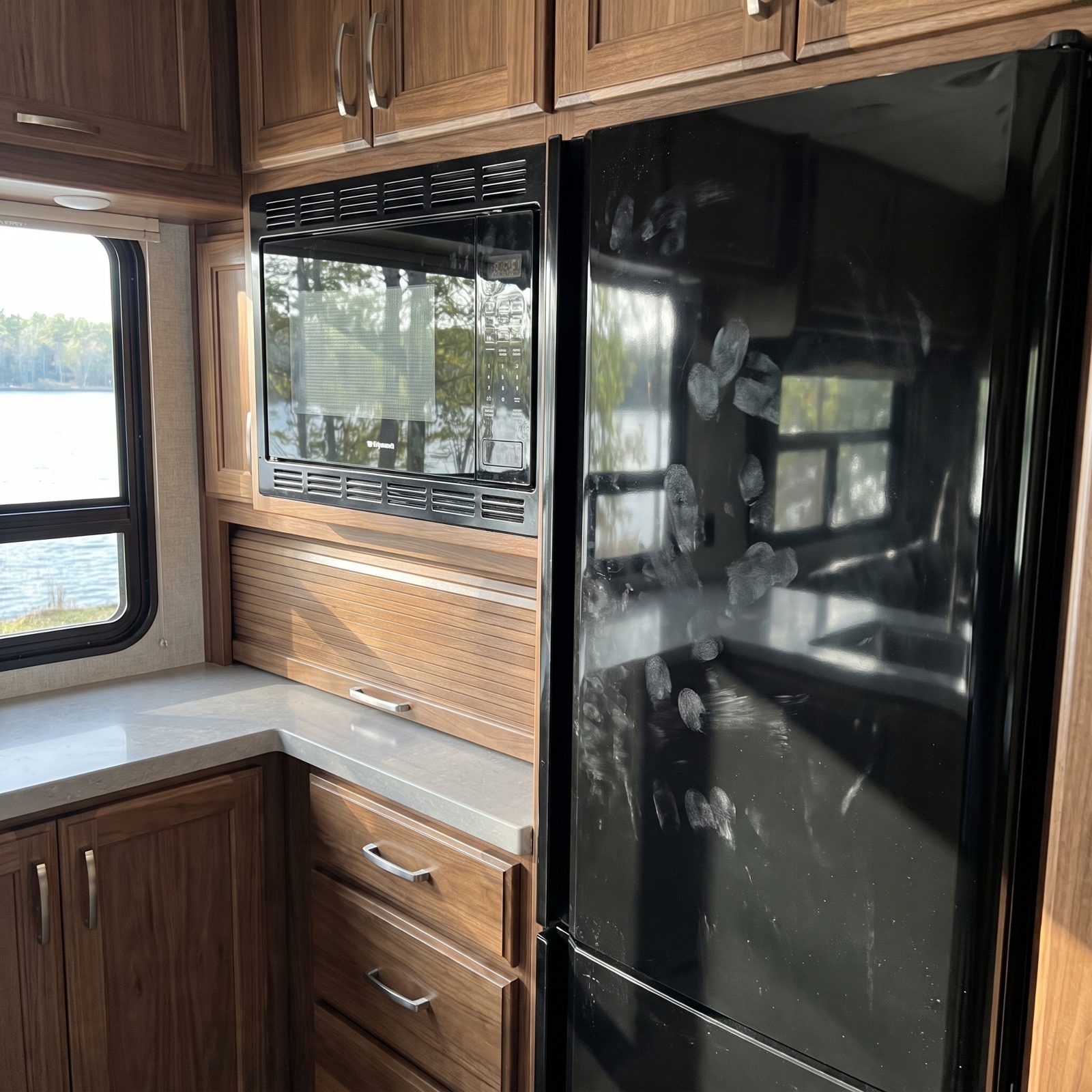 The Glossy Black Appliance Fronts That Wear Every Fingerprint Like a Crime Scene