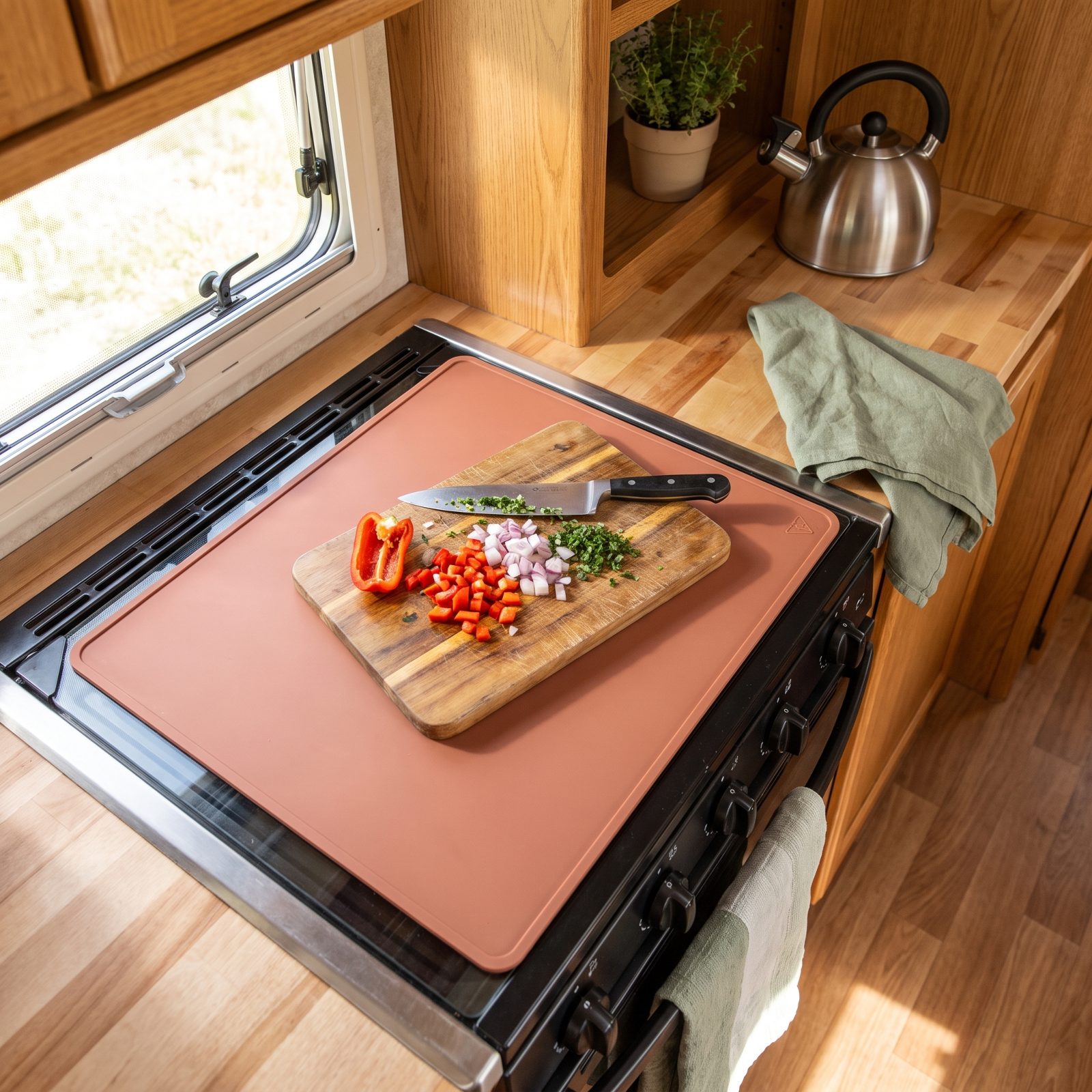 A Heat-Proof Silicone Mat That Turns the Stove Cover Into Counter Space