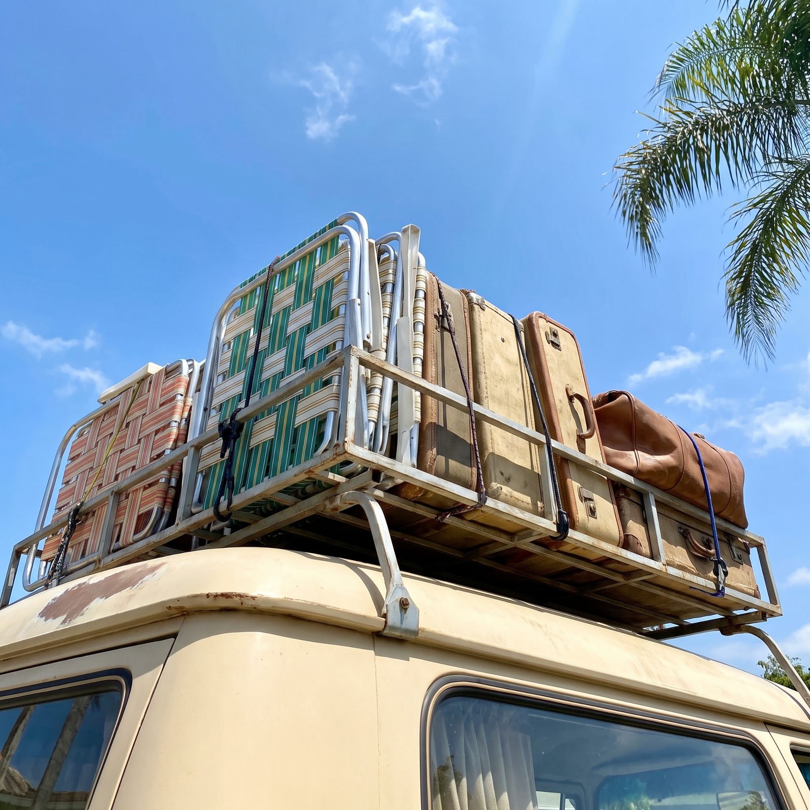 Metal Roof Racks Loaded With Lawn Chairs and Luggage