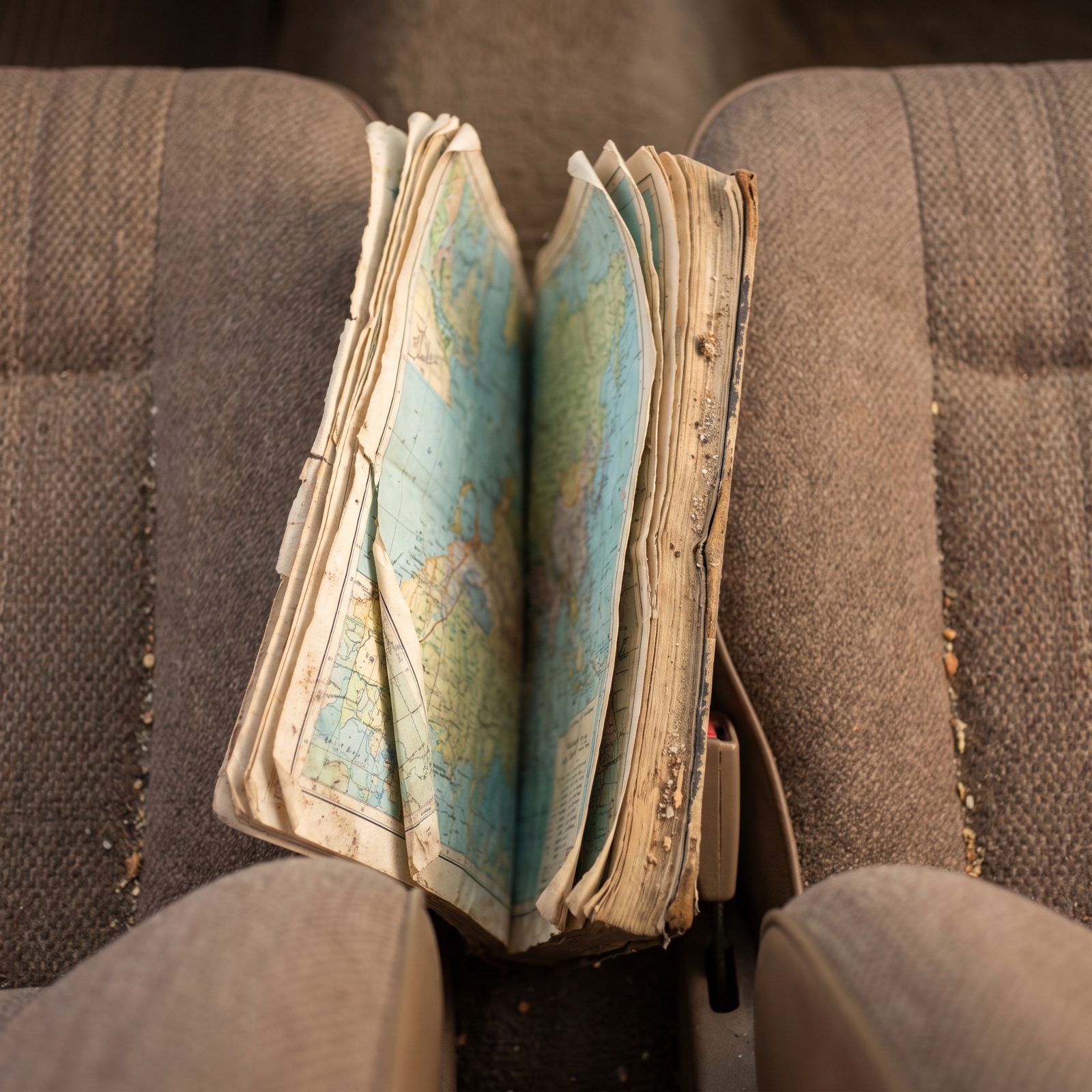 The Paper Atlas Jammed Between the Seats