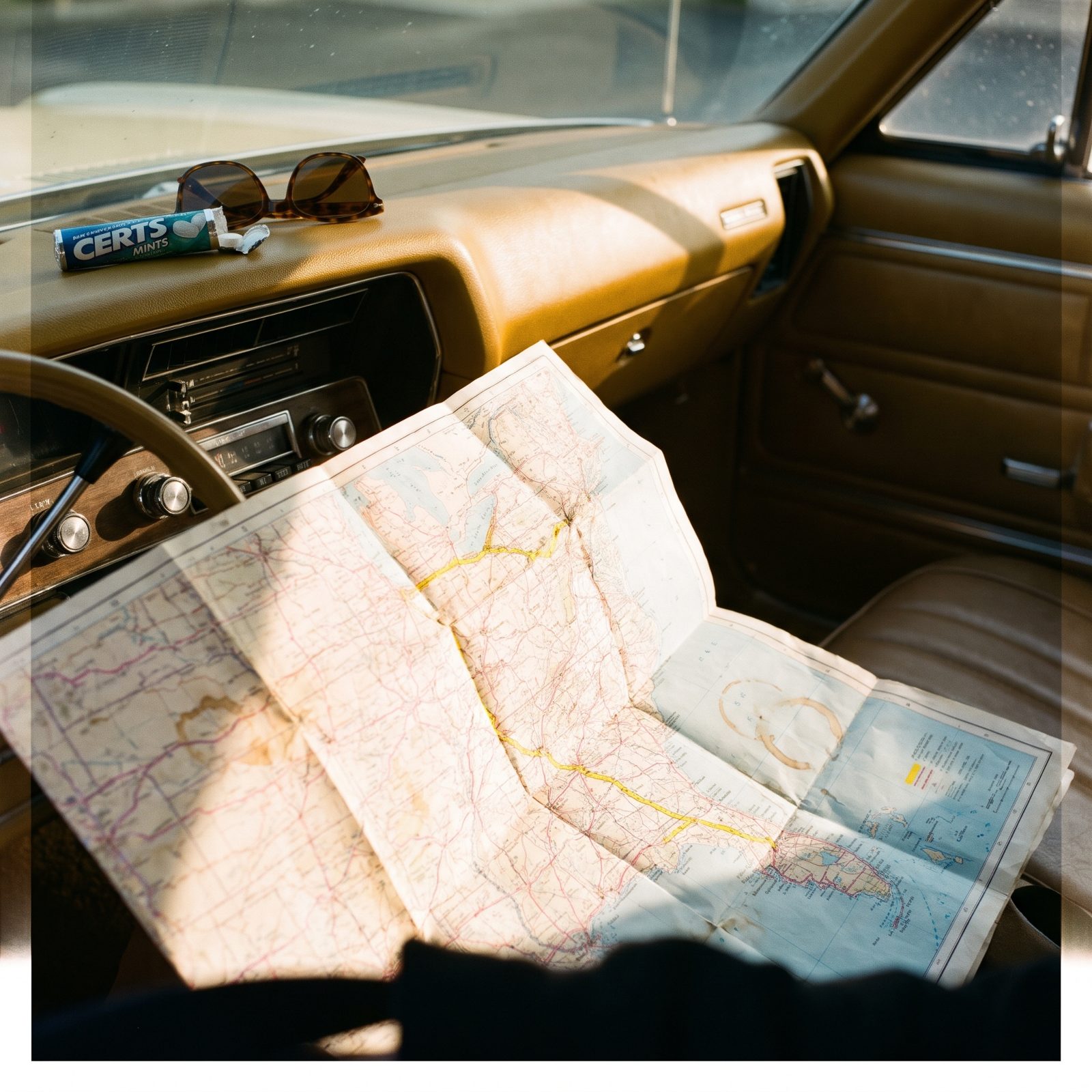 Paper Road Maps Spread Across the Dashboard