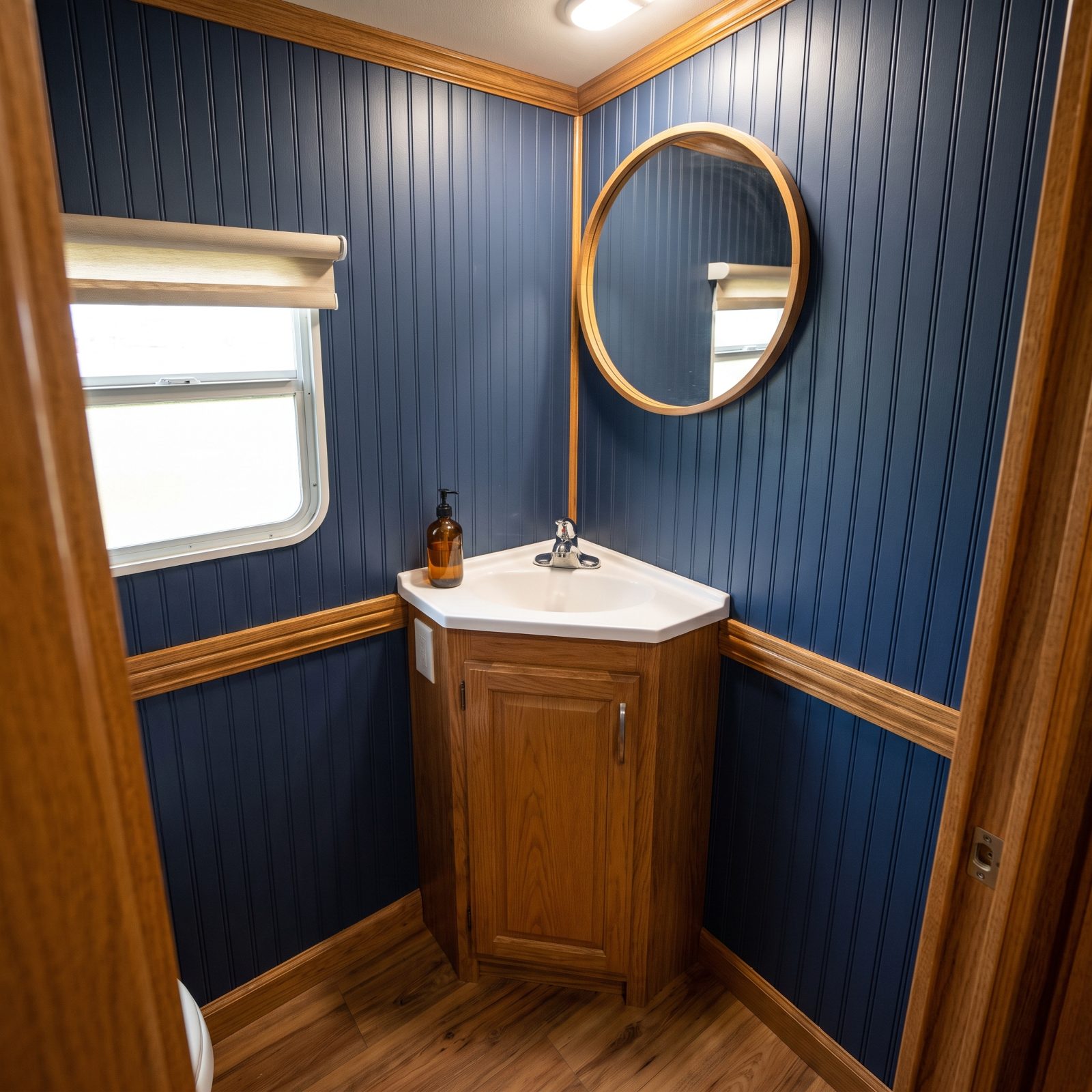 Use a compact corner sink to recover bathroom standing room